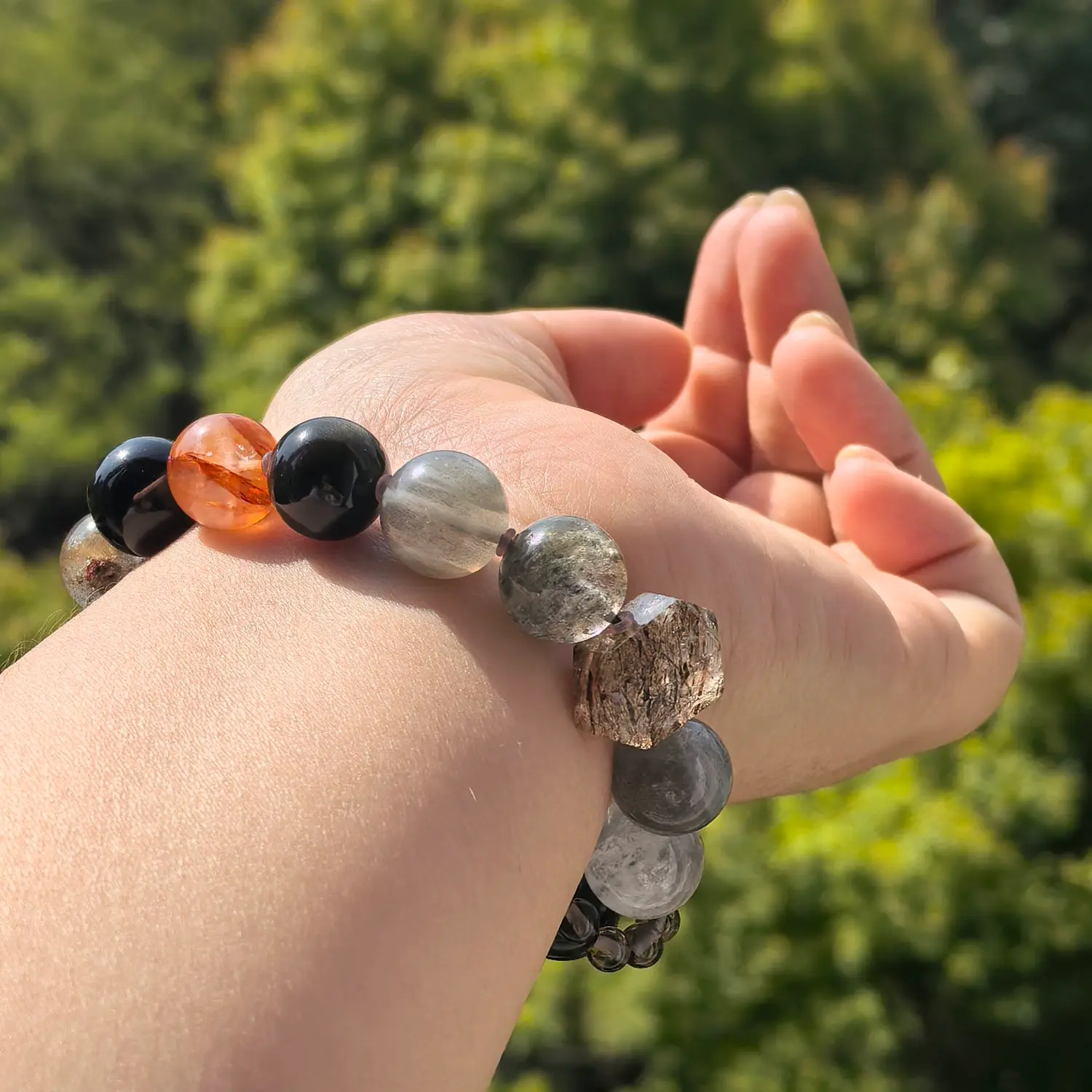Clear Quartz Obsidian Red Hematoid Quartz Bracelet worn on wrist in natural light | QZZEN