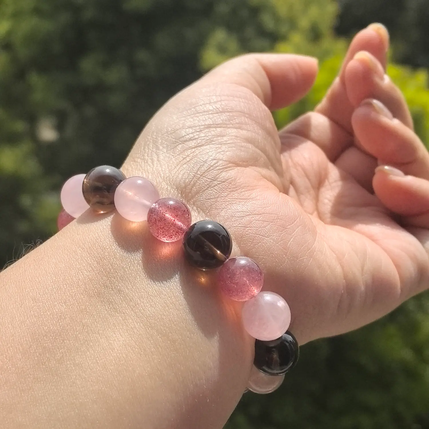 Rose Quartz Strawberry Quartz Smoky Quartz Bracelet worn on wrist in natural light | QZZEN