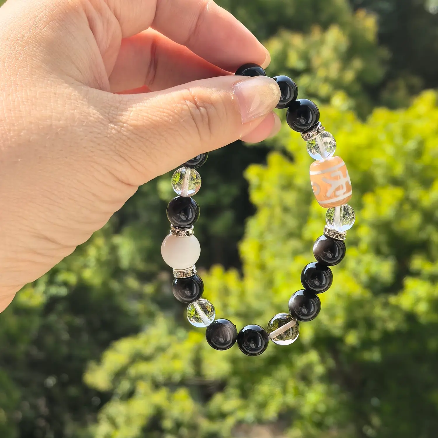 Clear Quartz Silver Obsidian Bracelet styled flat lay with calm ritual details | QZZEN