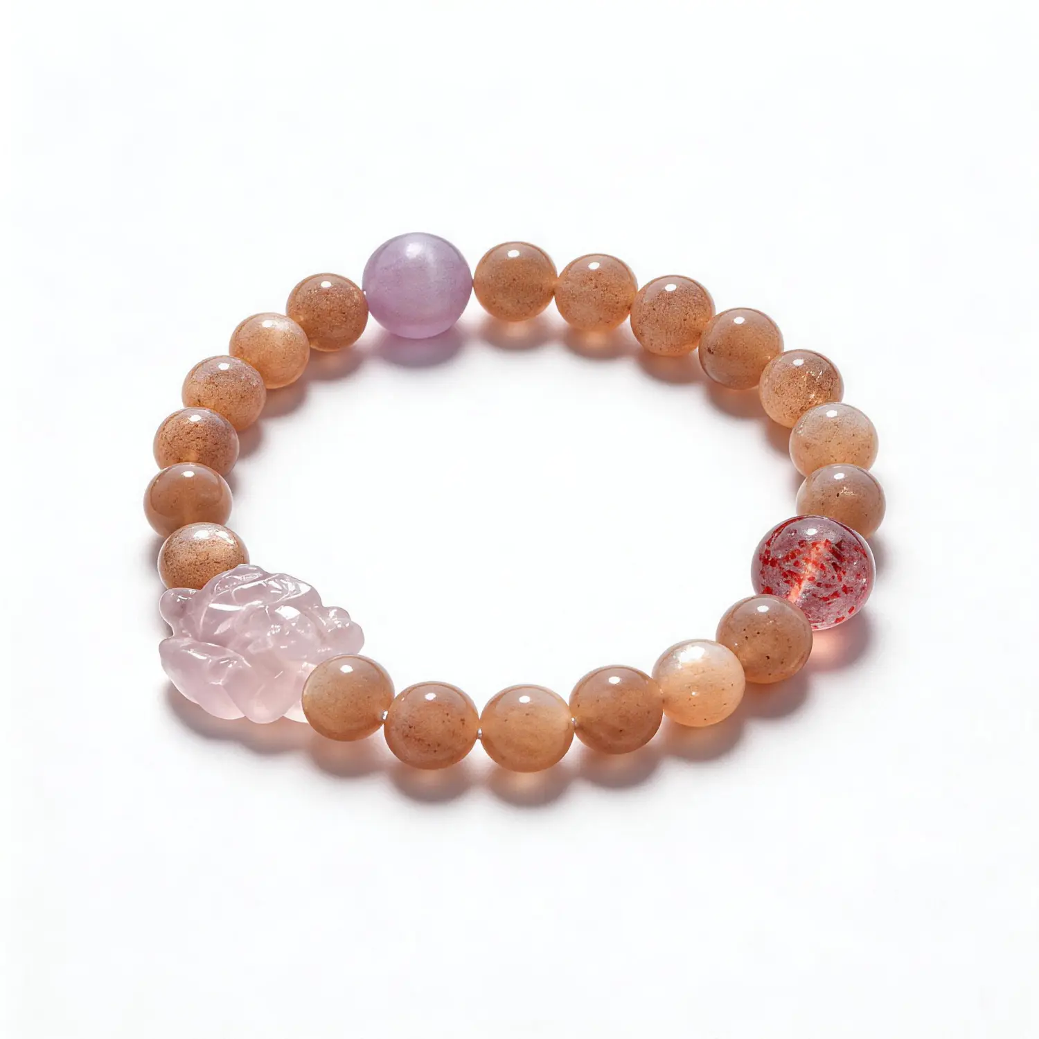 Peach stone bracelet with carved pink and purple accents
